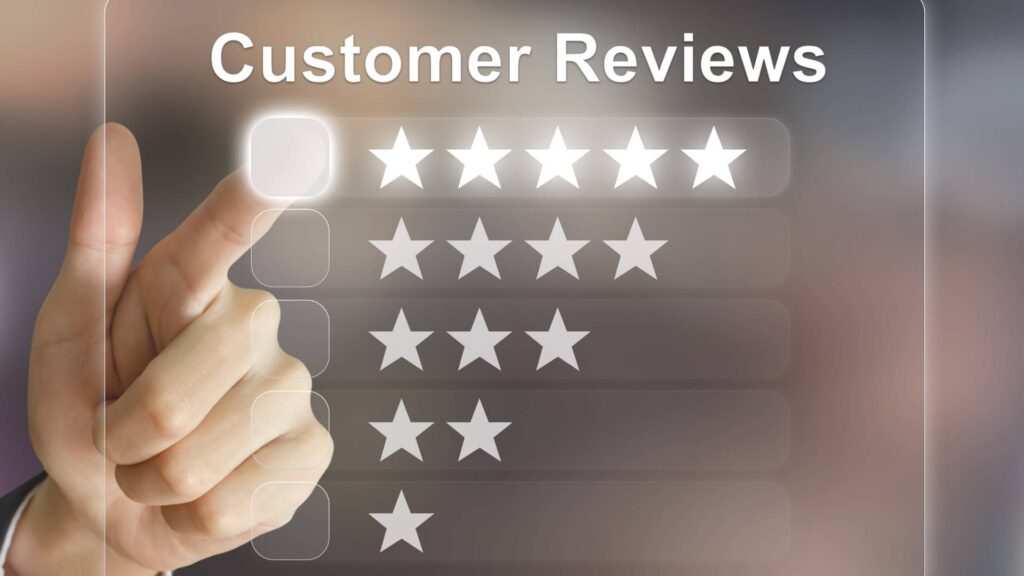 A hand pointing to a five-star rating on a transparent digital screen under the heading "Customer Reviews," symbolizing customer feedback and online reputation.